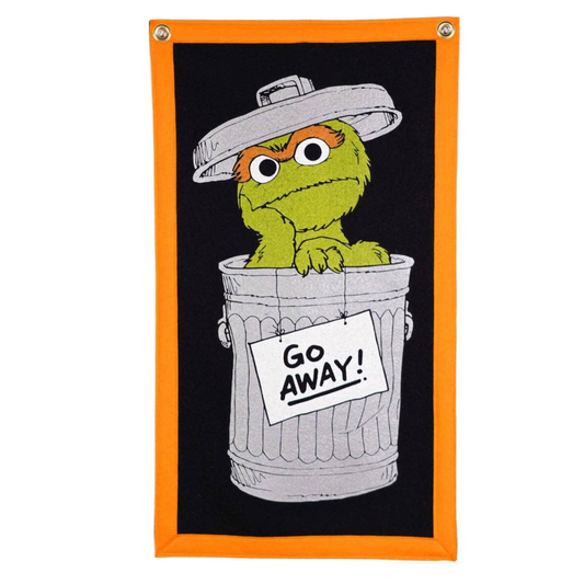 Oscar the grouch in a trash can with 'Go Away!' sign on a black background