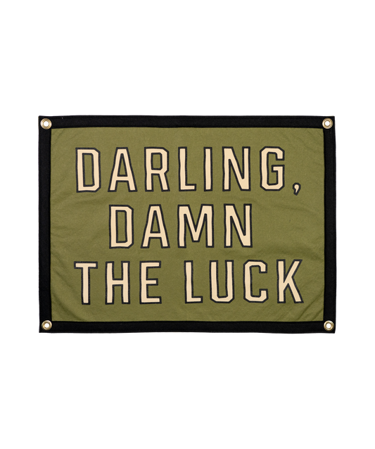 Green banner with text 'Darling, damn the luck' on a white background