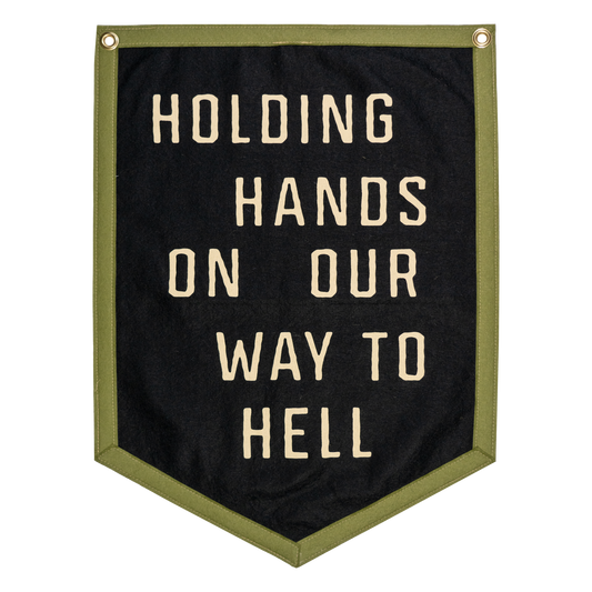 Black banner with white text 'Holding hands on our way to hell' with a green border